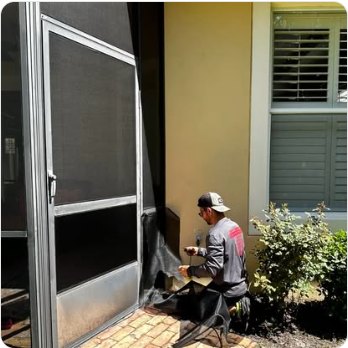 Screen door being fitted at the side of a house