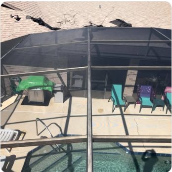 Inside a rescreened pool enclosure looking out over the deck