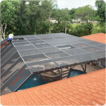 Pool cage roof panels replaced above a tile-roofed home