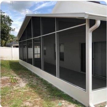 White-framed screen enclosure along the side of a house